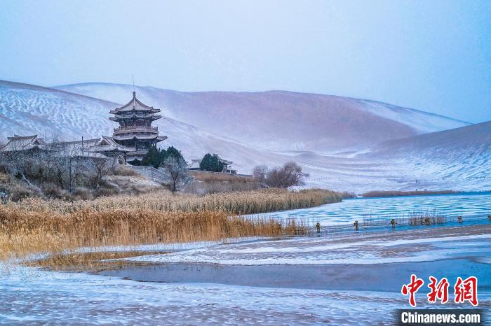 2021年11月28日，雪落鳴沙山月牙泉景區(qū)。　王斌銀 攝